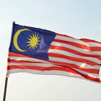 Close up of Malaysia flag flying in the sky
