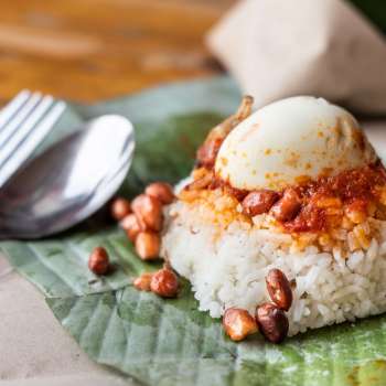 Simple authentic nasi lemak wrapped in banana leaf, popular breakfast in Malaysia